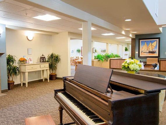 A cozy lobby area featuring a grand piano and inviting decor.
