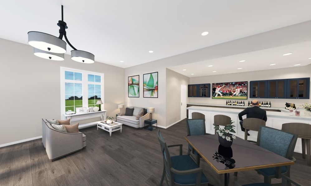 A modern living room with open space, stylish furniture, and wood flooring.