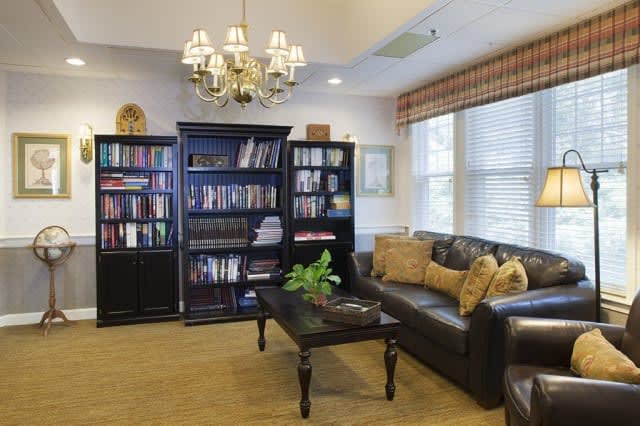 A cozy living room with bookshelves and comfortable seating.