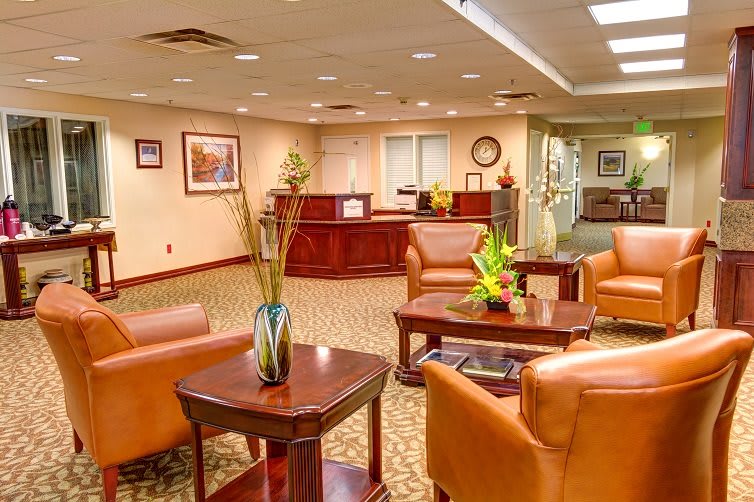 A well-furnished lobby with comfortable seating and a reception desk.