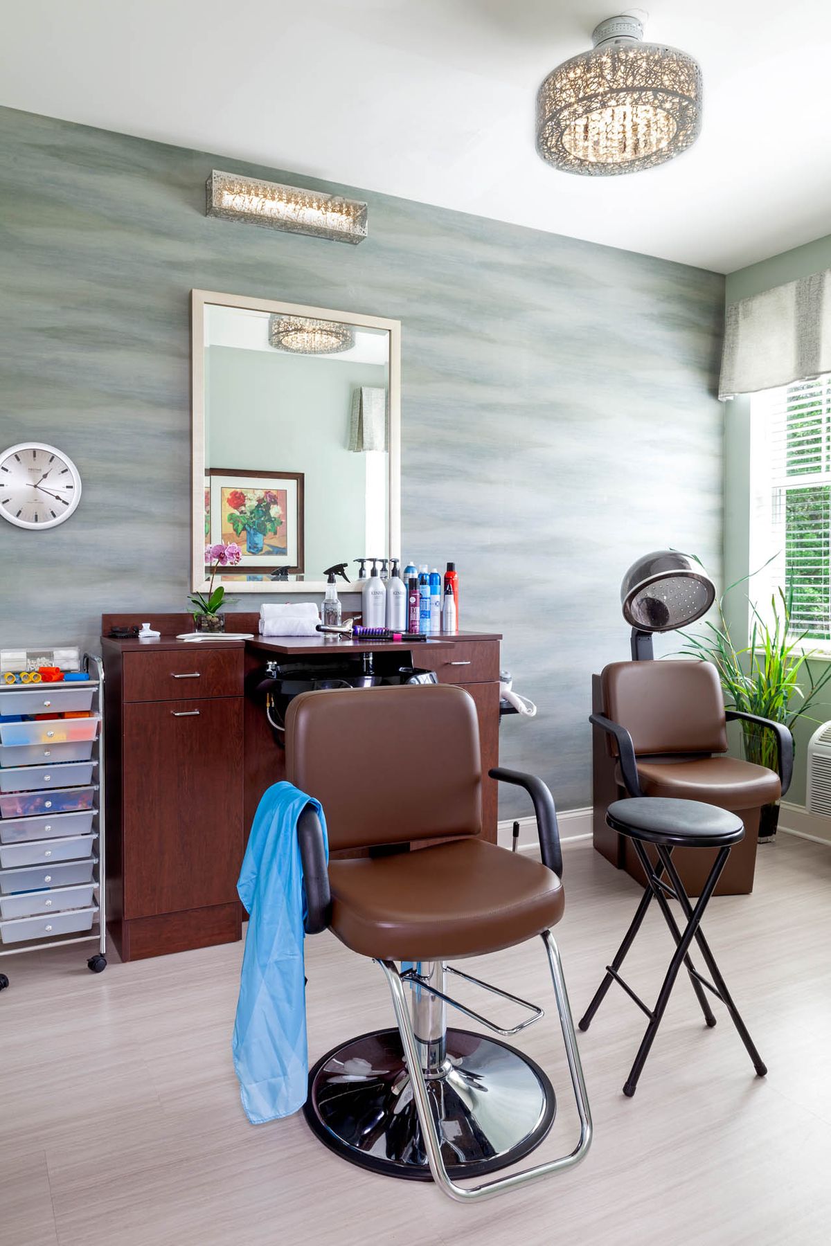 A well-organized hair salon interior with chairs, a mirror, and salon equipment.
