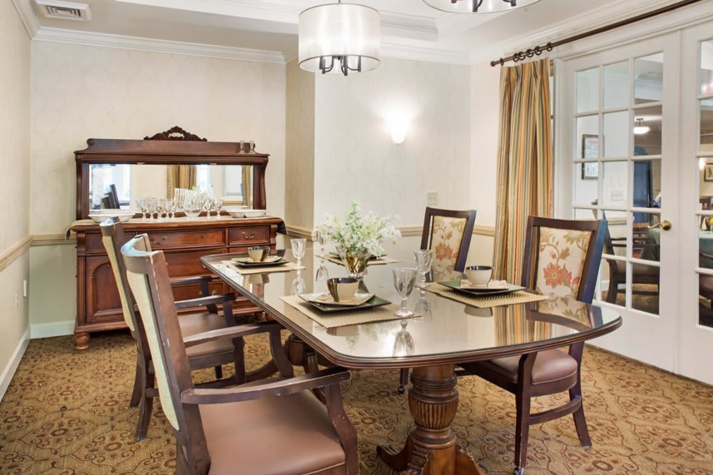 A classic dining room setup with a wooden table, chairs, and elegant decor.