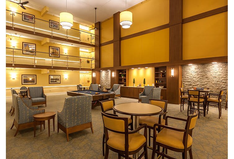 A spacious hotel lobby with comfortable seating and warm lighting.