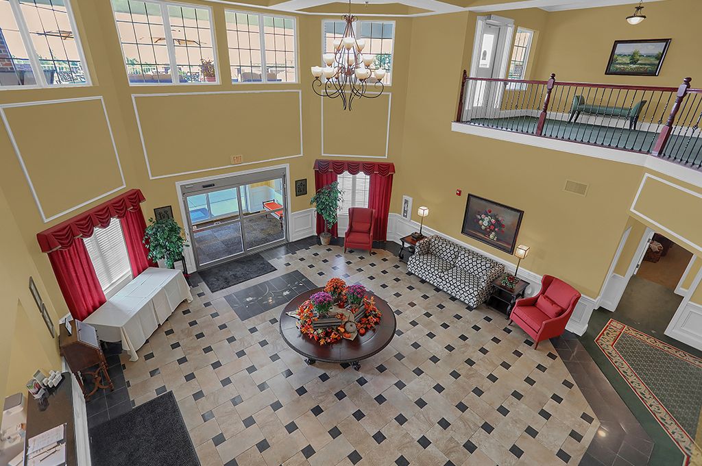 A spacious lobby with elegant furnishings and a chandelier.