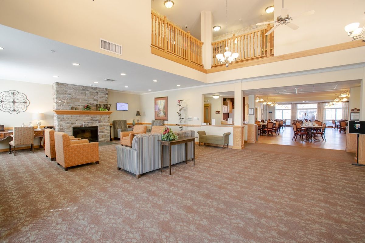 A spacious and modern living room area with comfortable seating and a cozy fireplace.