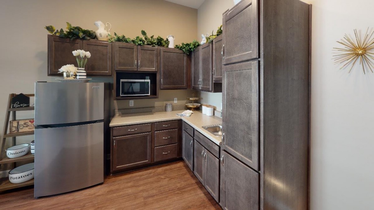 A modern kitchen with wooden cabinets and stainless steel appliances.