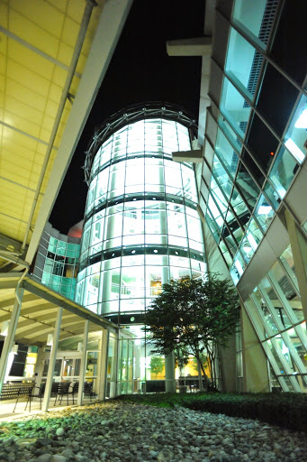 A modern glass structure illuminated at night, showcasing contemporary architectural design.