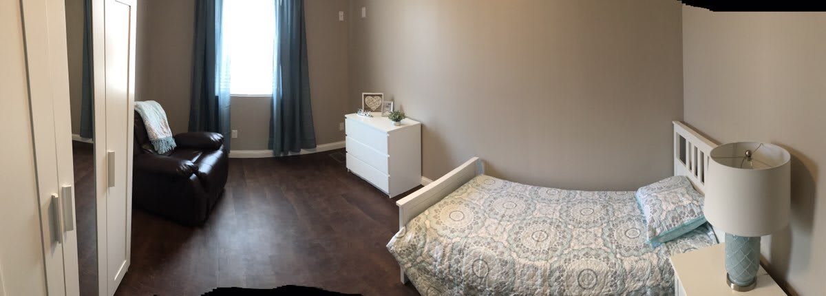 A minimalist bedroom with a single bed and a white dresser.