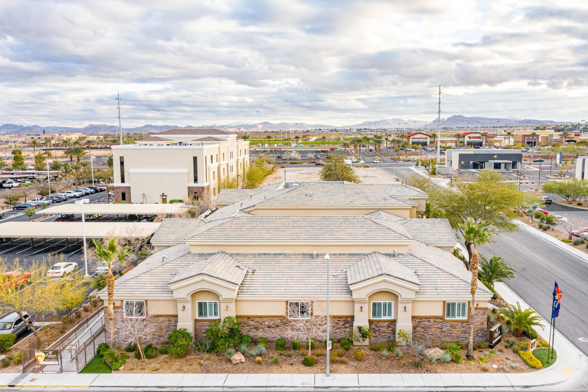A suburban area with buildings under a cloudy sky.