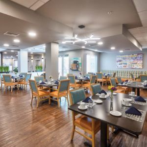 A modern and cozy restaurant dining area with neatly arranged tables and chairs.