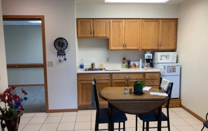 A cozy kitchen with wooden cabinets and a small dining table.