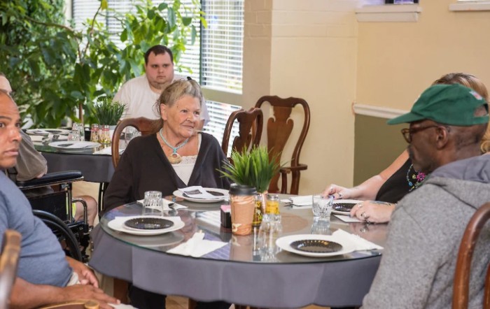 A group of people enjoying a meal together at a restaurant.