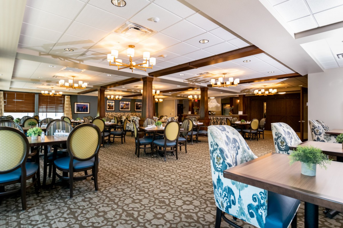 Elegant dining area with plush seating and ornate chandeliers.