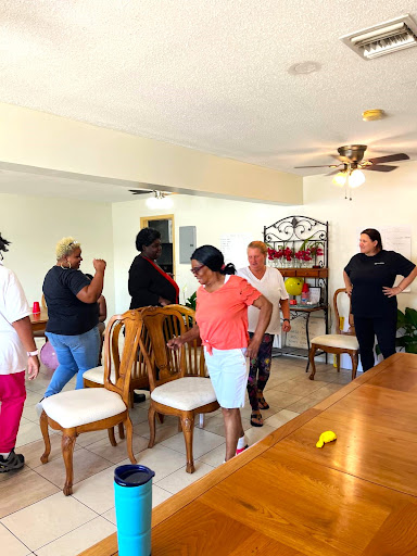 A group of individuals engaged in a cleaning activity in a cozy indoor setting.