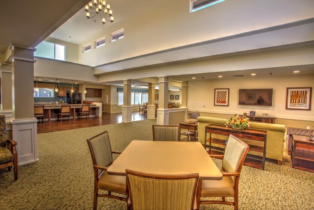 A spacious and modern interior with a dining area and lounge seating.