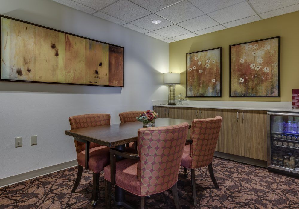 A cozy dining room with elegant furniture and decorative artwork on the walls.