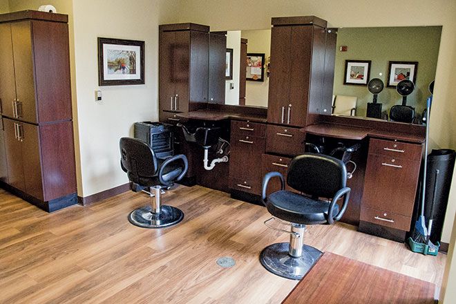 An interior view of a beauty salon with hairdressing chairs and mirrors.