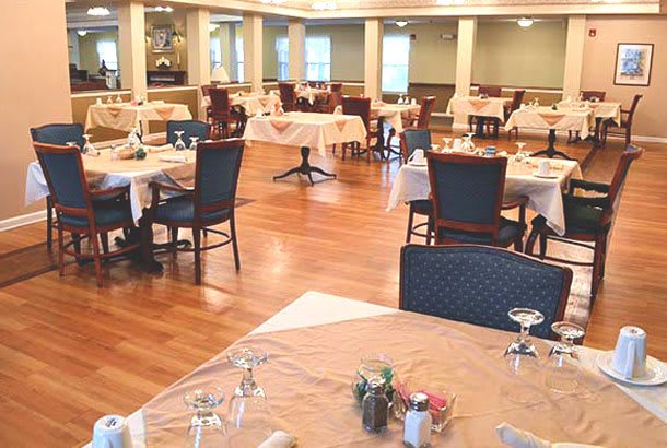 A spacious and elegant dining area with neatly set tables and comfortable chairs.