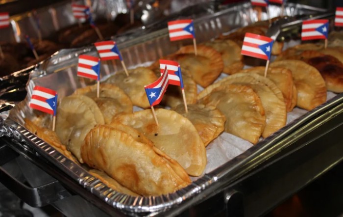 A tray of empanadas adorned with Puerto Rican flags.