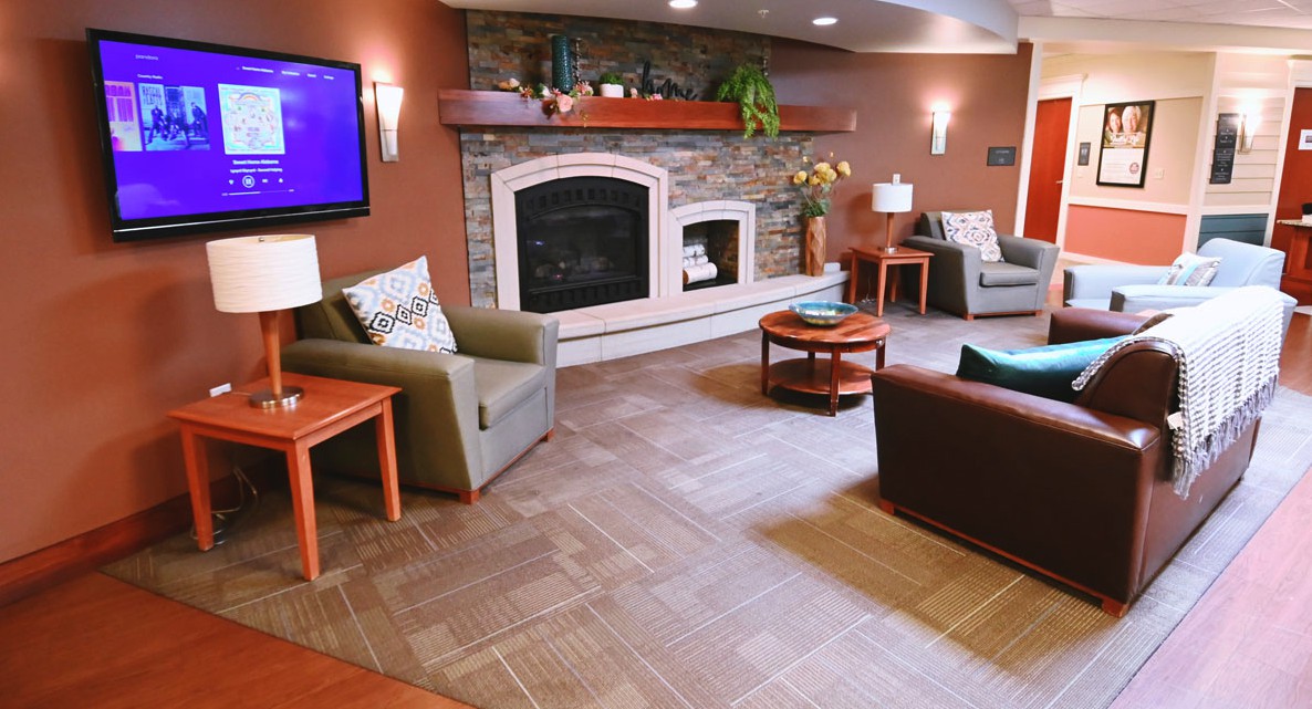 A cozy living room with a modern fireplace and comfortable seating arrangements.