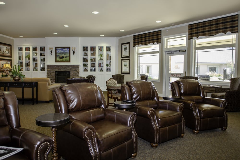 A cozy living room featuring leather recliners and a fireplace.