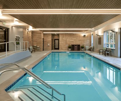 An elegant indoor swimming pool in a luxury hotel setting.