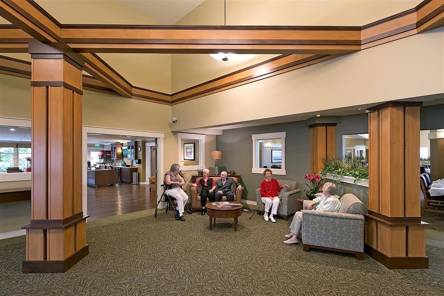 A group of people sitting and relaxing in a comfortable lobby area.