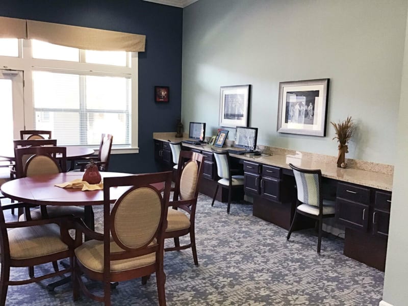 A well-organized office space with multiple workstations and a meeting table.