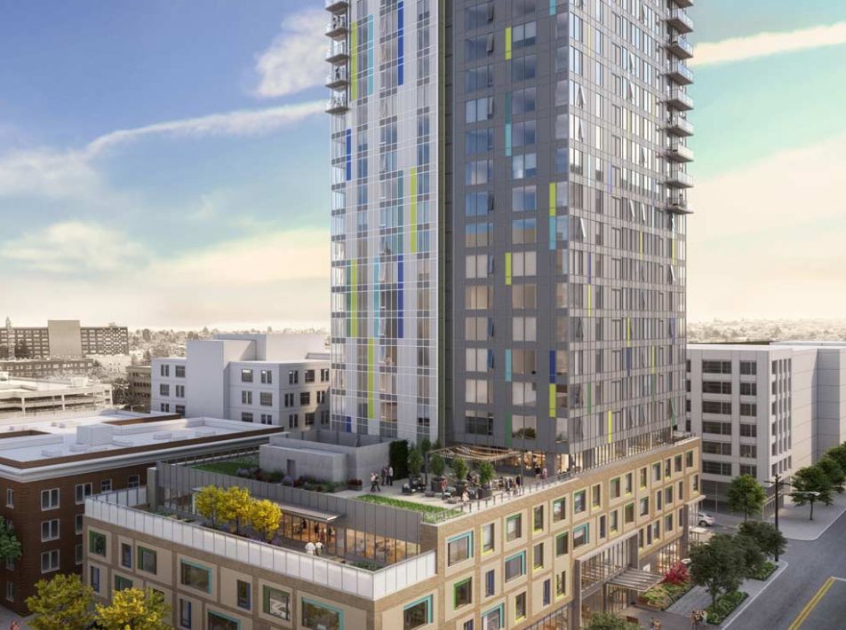 A modern high-rise building towering over the cityscape with a rooftop garden area.