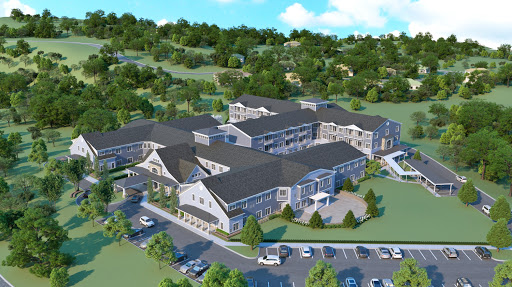 An aerial view of a modern residential complex surrounded by lush greenery.