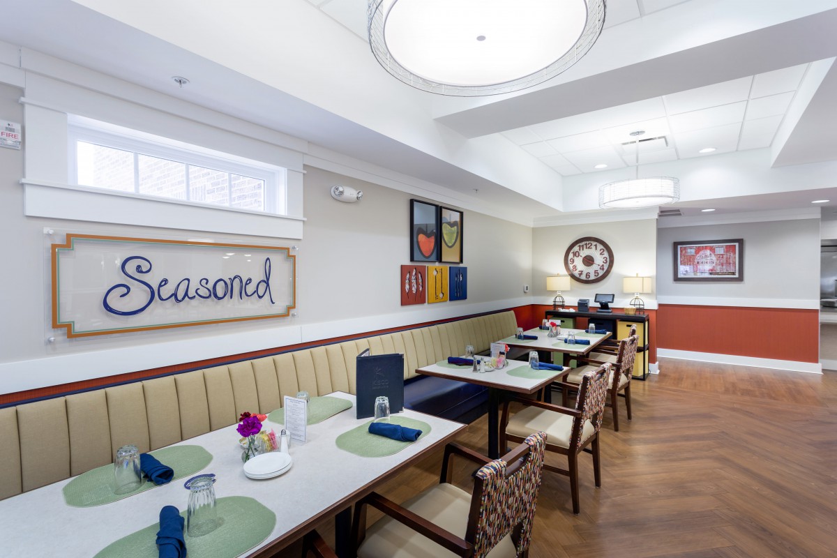A modern restaurant dining area with neatly arranged tables and colorful decor.