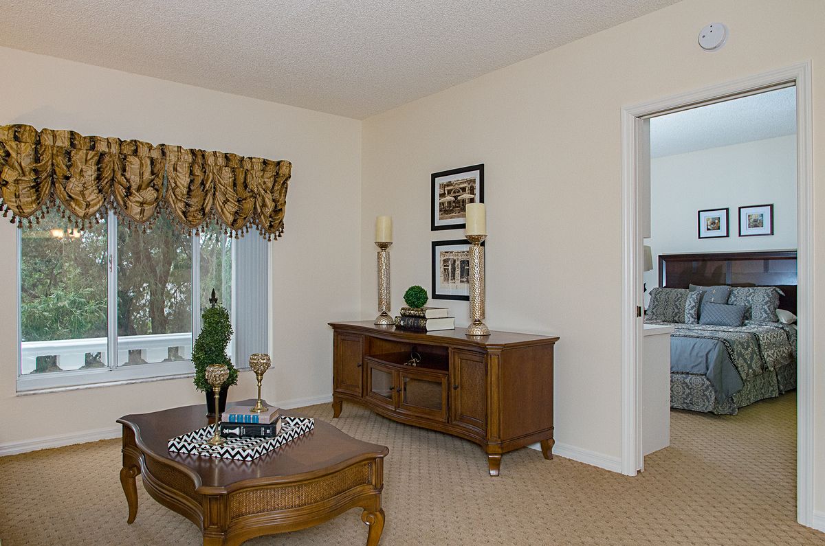 A traditional living room with wooden furniture and elegant decor.