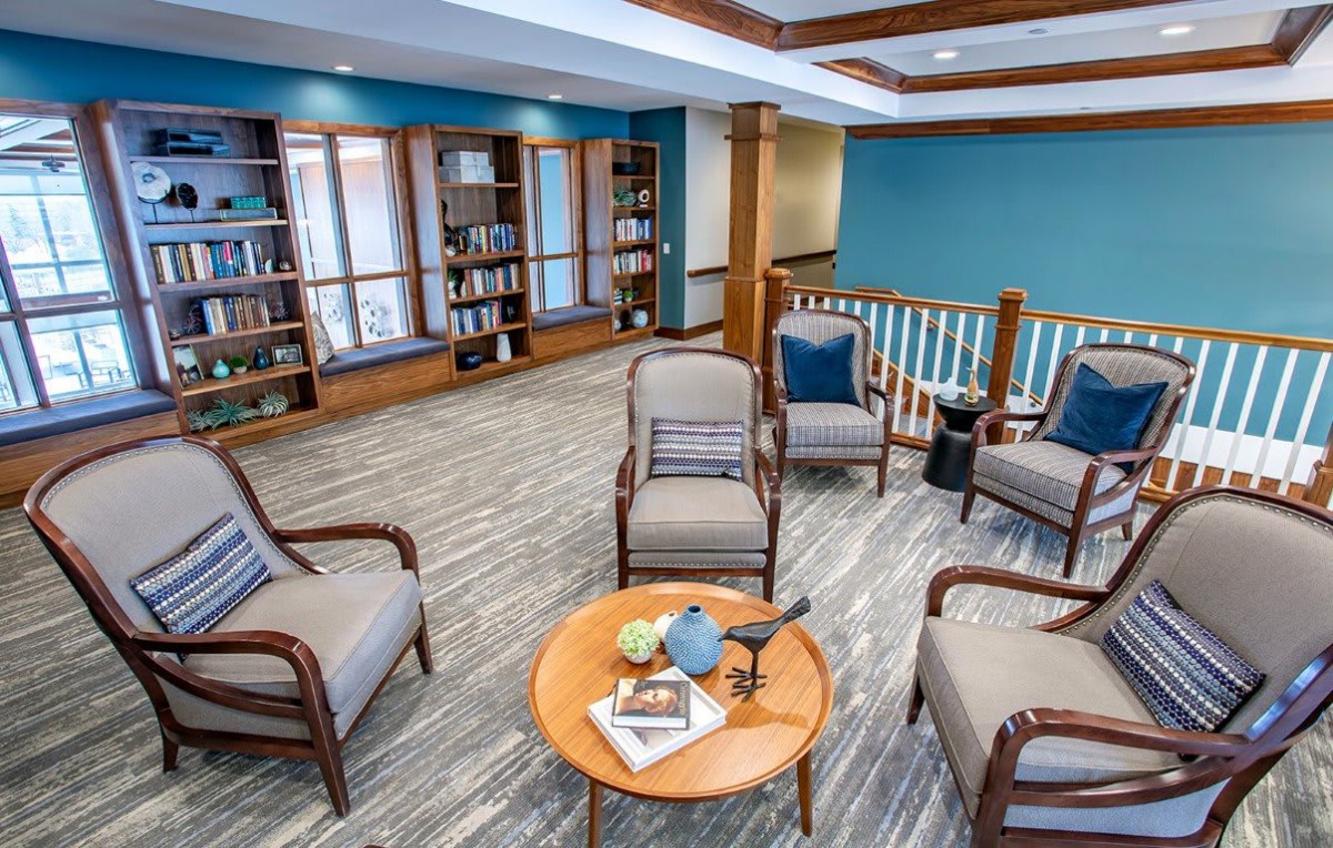A cozy reading area with comfortable chairs and bookshelves.