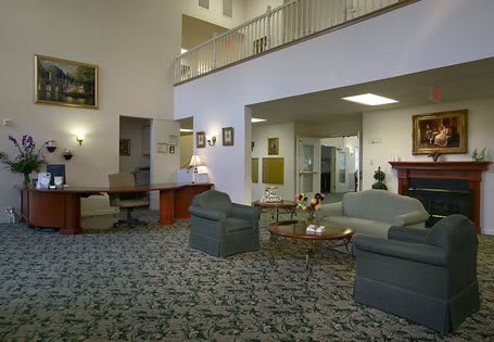 A comfortable lobby area featuring sofas, a coffee table, and soft lighting.
