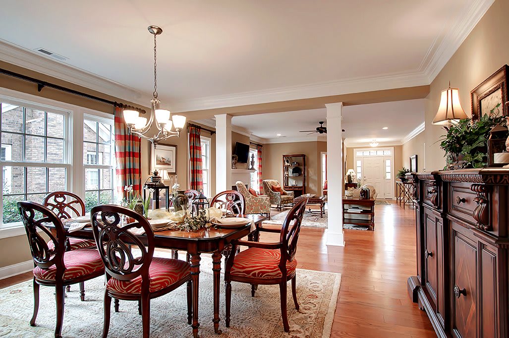 A beautifully decorated dining room with elegant furniture and an open concept design.