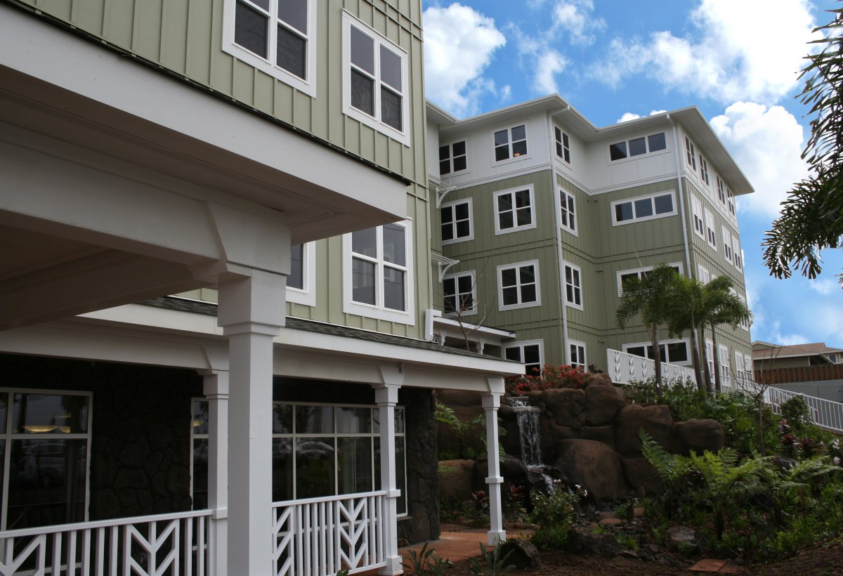 Modern residential buildings with multiple windows against a blue sky.