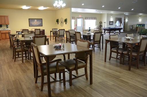 A spacious dining area featuring wooden tables and chairs, designed for comfort and social gatherings.