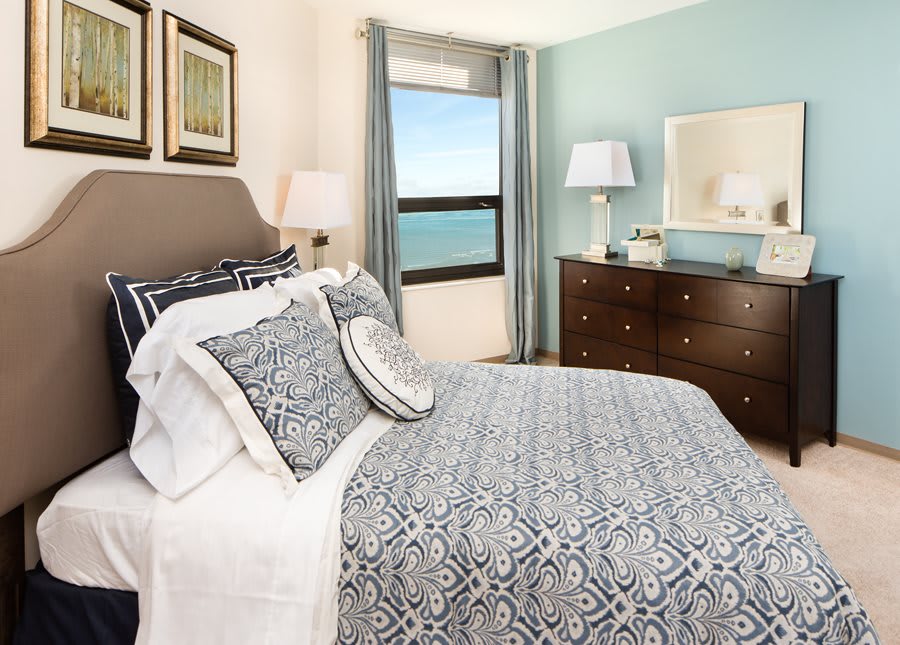 A cozy bedroom with coastal views and elegant decor.