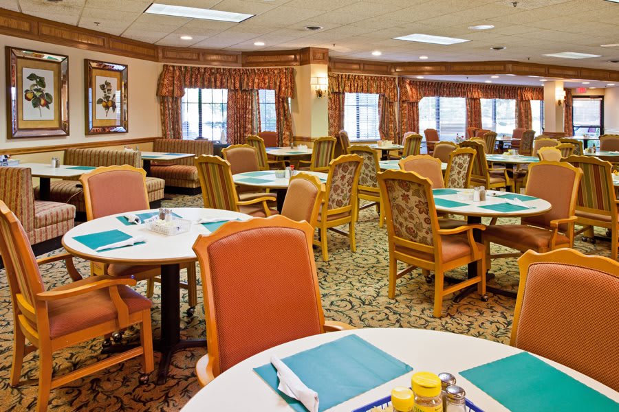 A cozy dining room with neatly arranged tables and chairs.