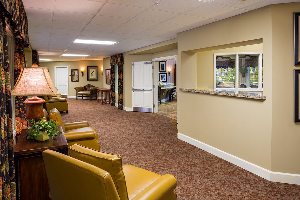 A cozy lobby area with comfortable seating and a reception window.