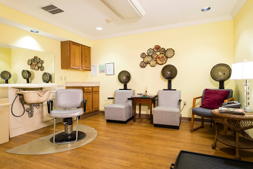 A cozy hair salon waiting area featuring stylish seating and professional hair styling stations.