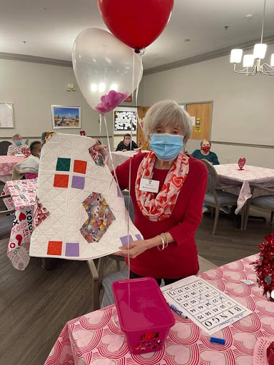 A joyful gathering at the senior center, showcasing creative crafts and decorations for Valentine's Day.
