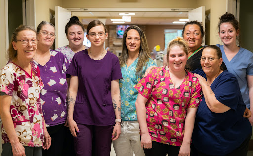 A dedicated team of healthcare professionals posing together in a hospital setting.