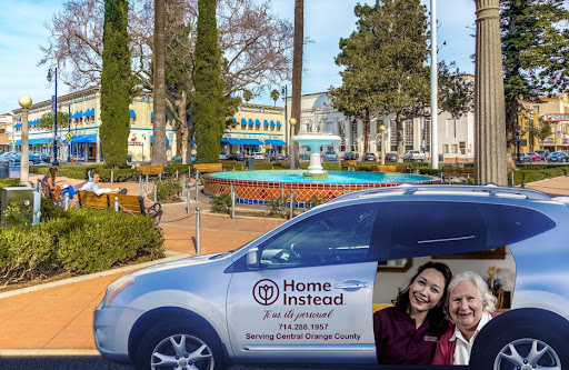 A Home Instead vehicle parked near a community area, promoting home care services.