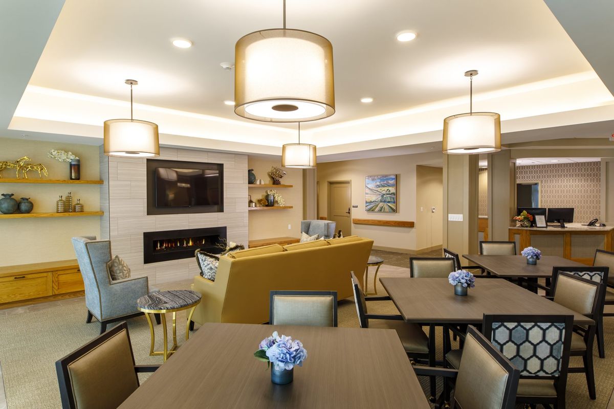 A modern lounge area with stylish lighting and comfortable seating.