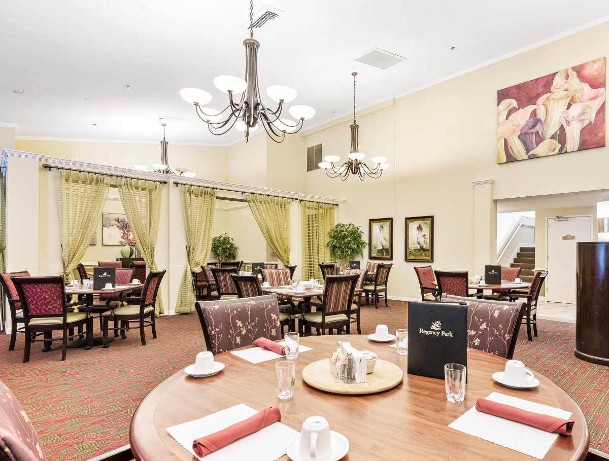 Elegant dining room with neatly arranged tables and soft lighting.