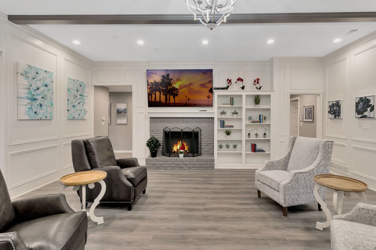 A modern living room with a cozy fireplace and elegant seating arrangement.