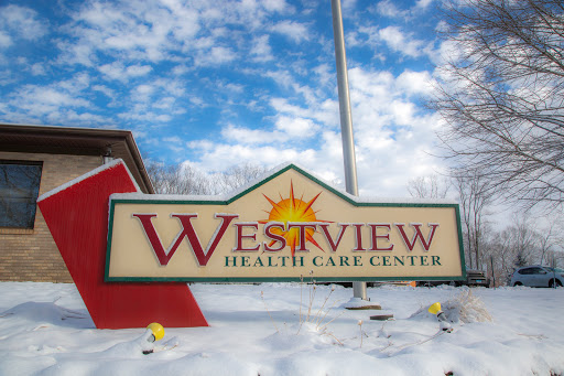 Westview Health Care Center sign displayed against a scenic snowy background.