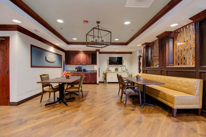 Modern dining area with wooden floors and contemporary furnishings.