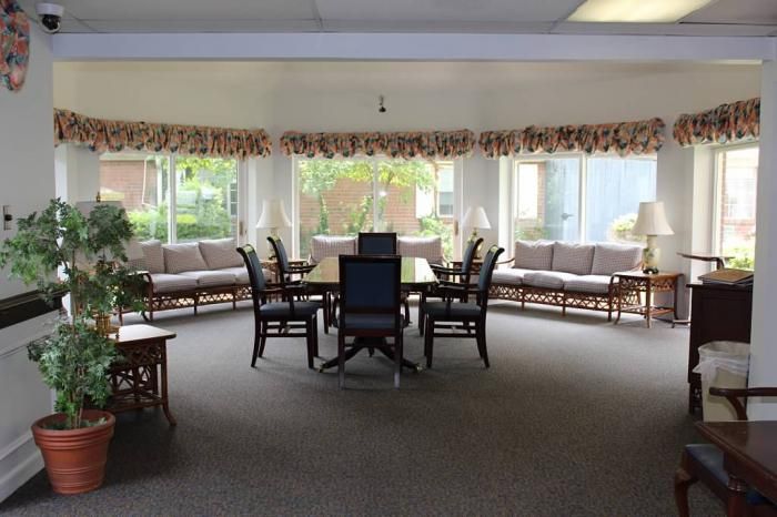 A bright lounge area with seating and large windows.
